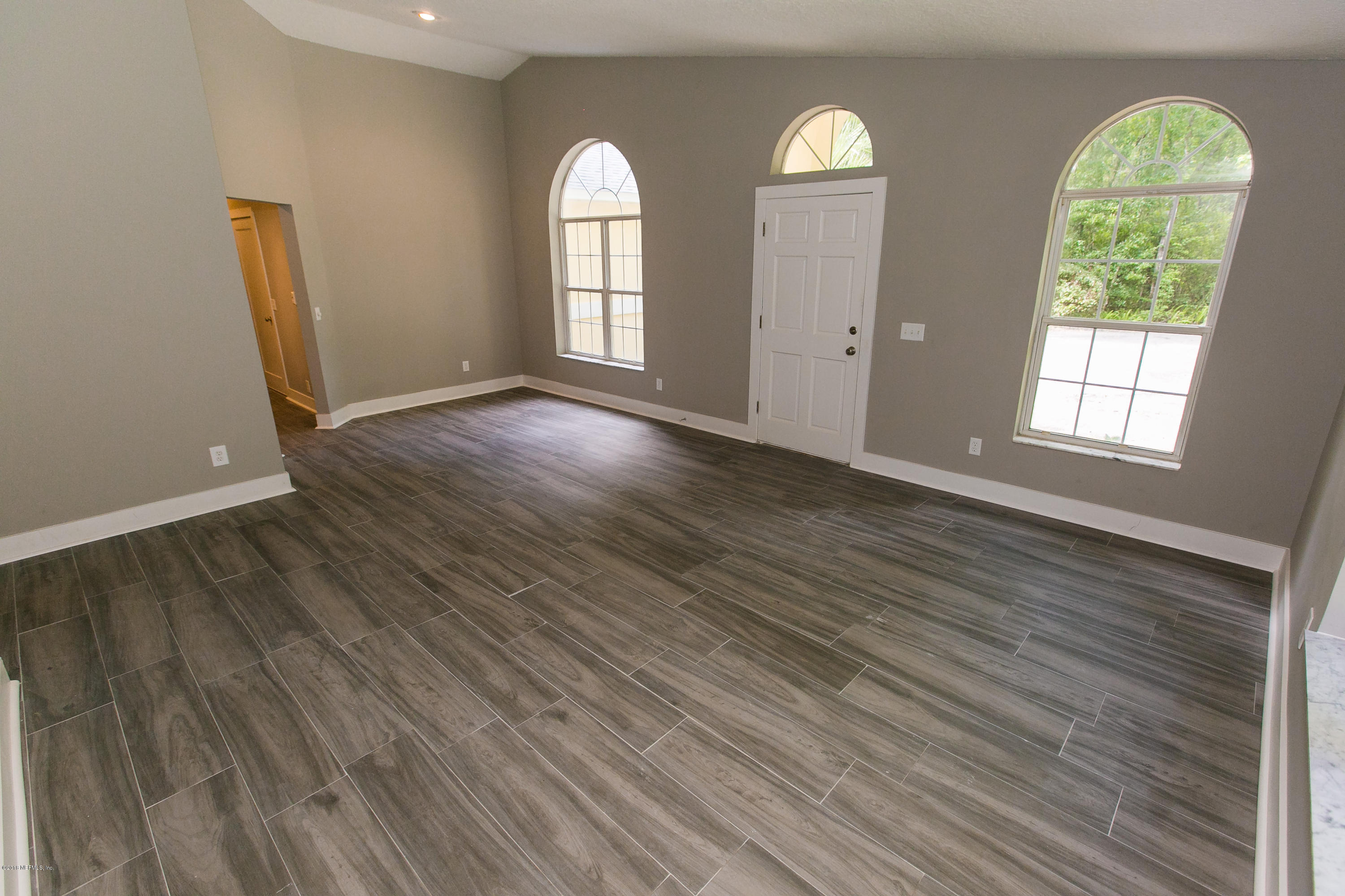 2225 Pacetti Road St. Augustine, FL 32092 - Photo 3 of 42 a view of empty room with wooden floor and window
