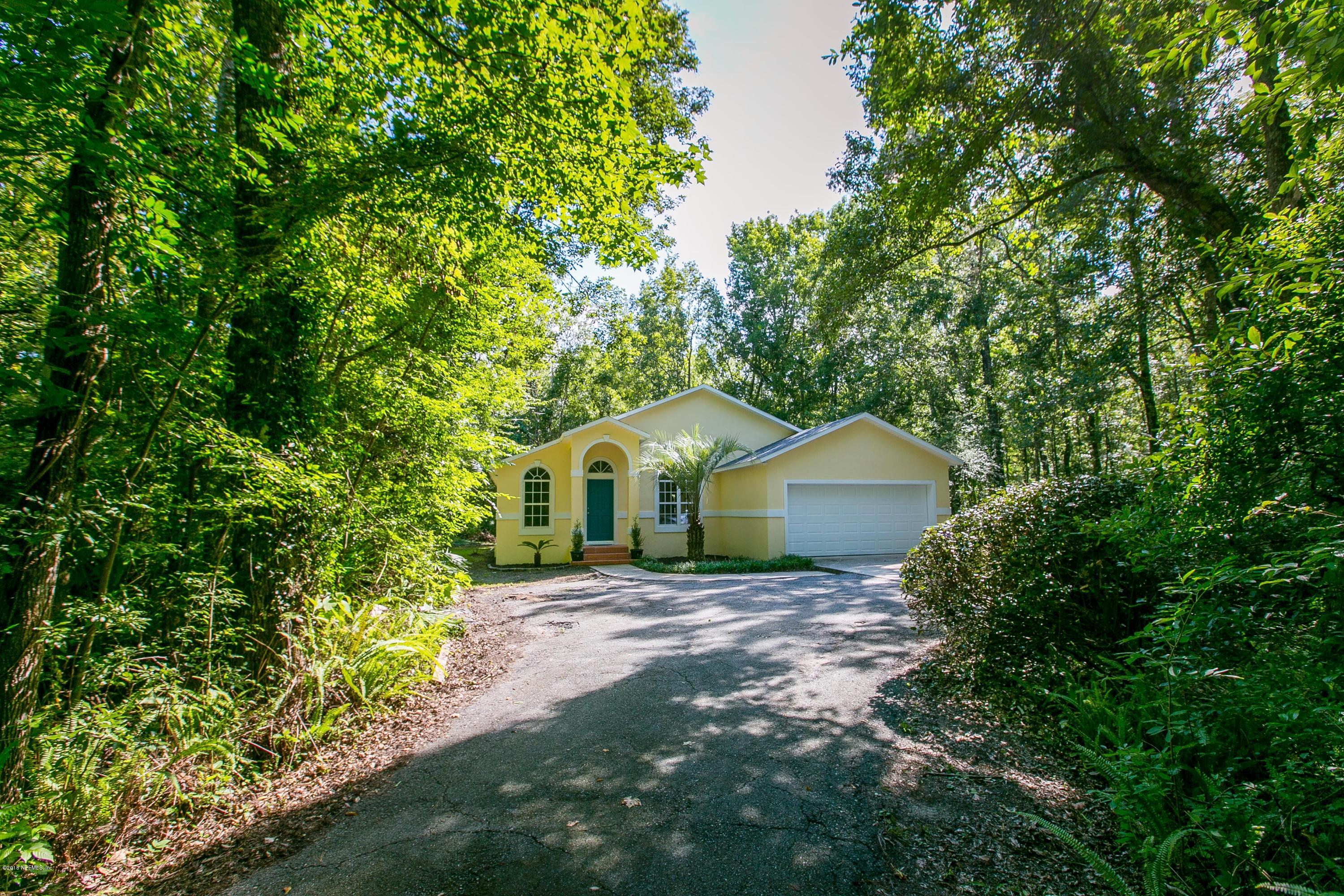 2225 Pacetti Road St. Augustine, FL 32092 - Photo 5 of 42 a front view of a house with a yard and large tree