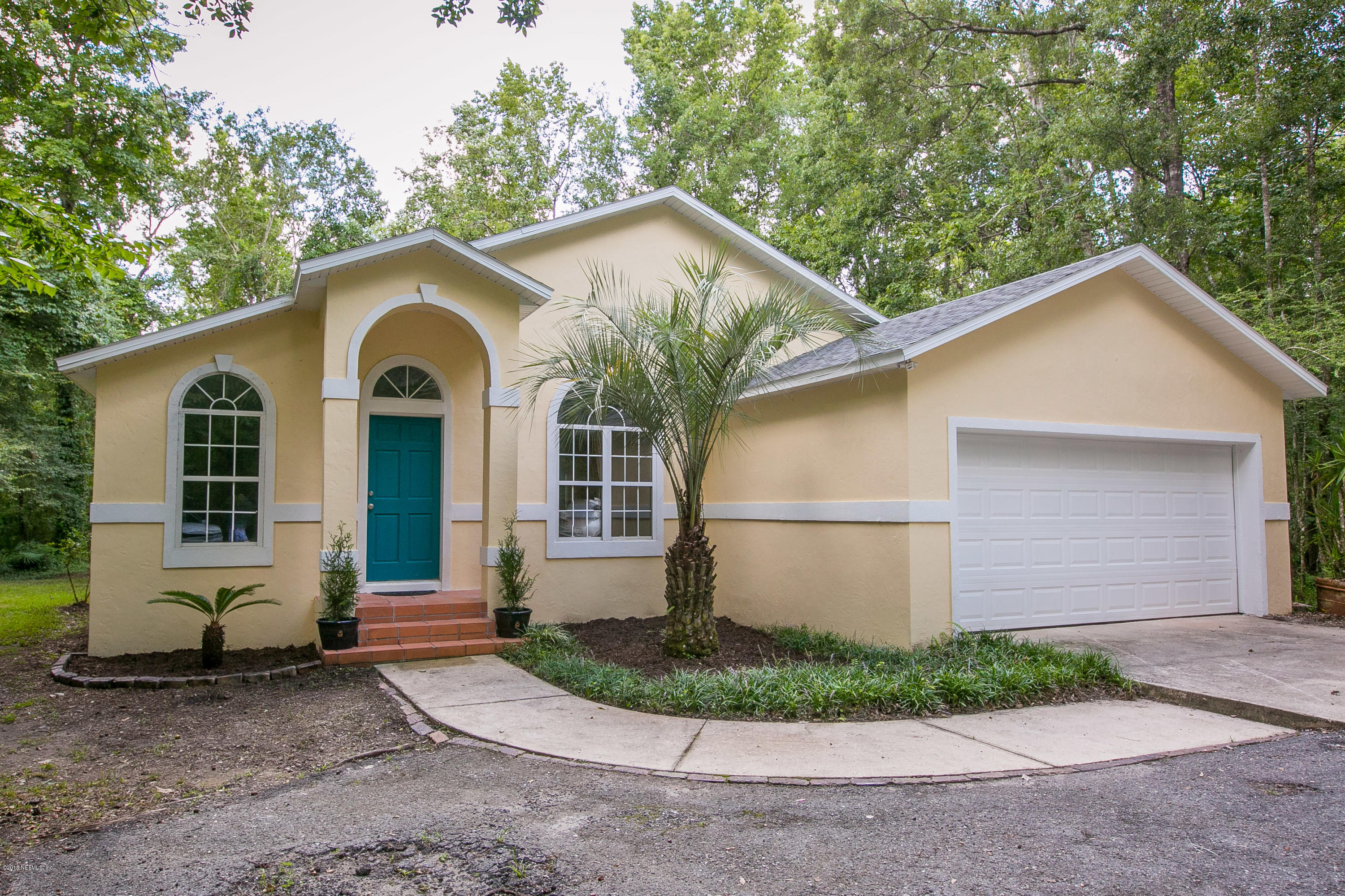 2225 Pacetti Road St. Augustine, FL 32092 - Photo 6 of 42 a view of a white house with a yard and large tree