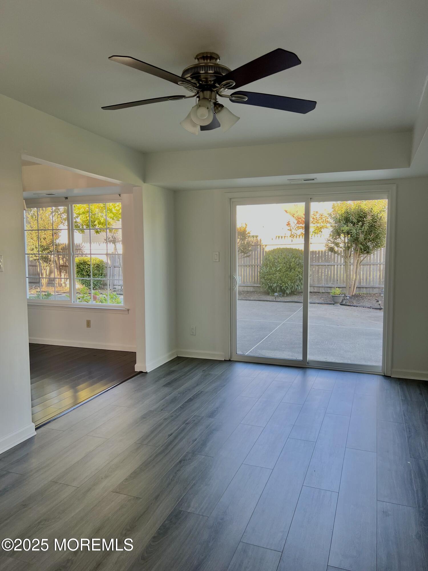 8 Hedgewood Road Howell, NJ 07731 - Photo 14 of 17 an empty room with wooden floor fan and windows