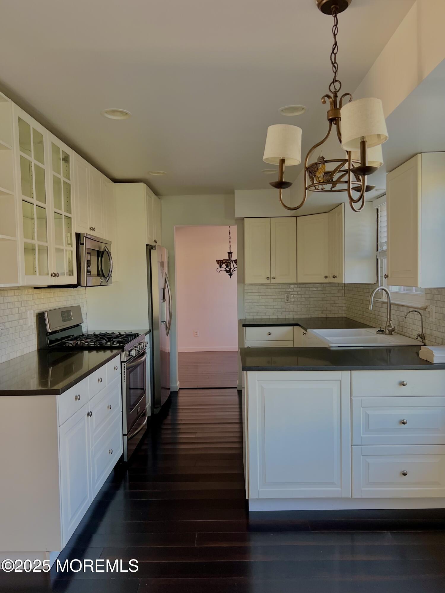 8 Hedgewood Road Howell, NJ 07731 - Photo 15 of 17 a kitchen with granite countertop white cabinets and white appliances