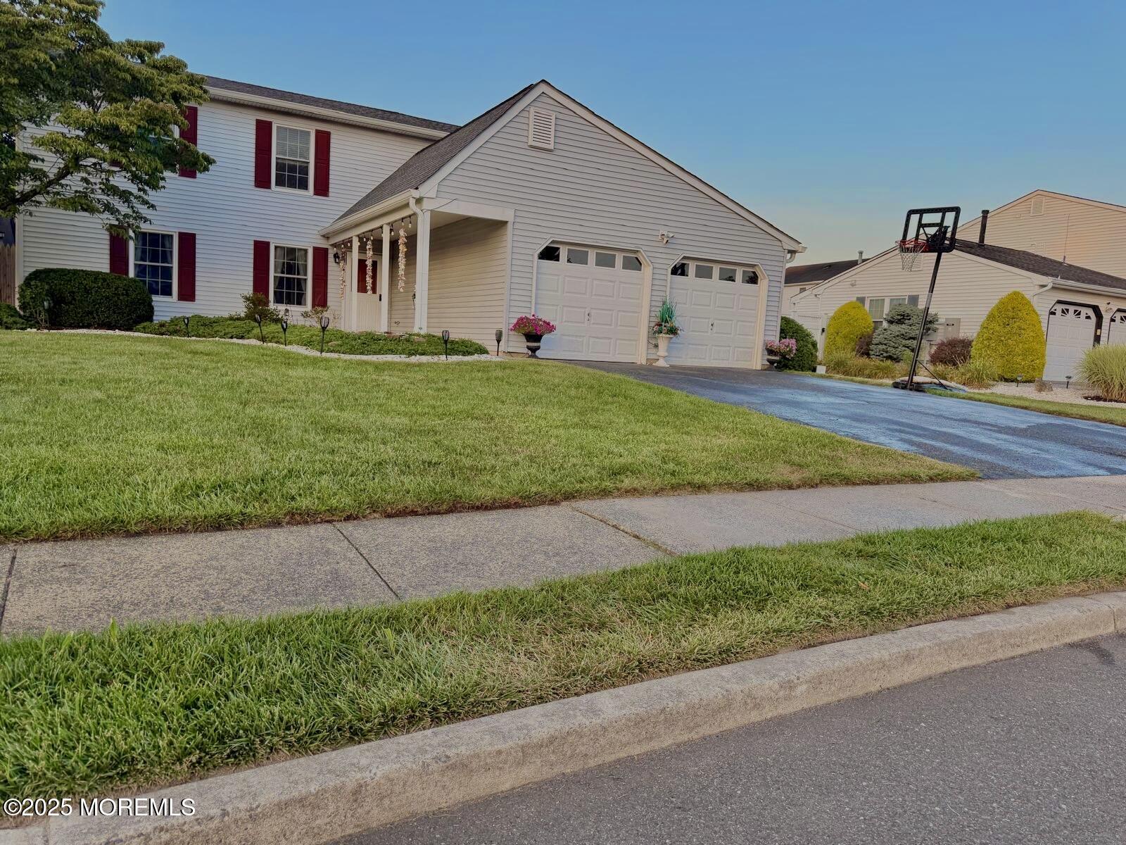 8 Hedgewood Road Howell, NJ 07731 - Photo 3 of 17 a view of a white house next to a yard and road
