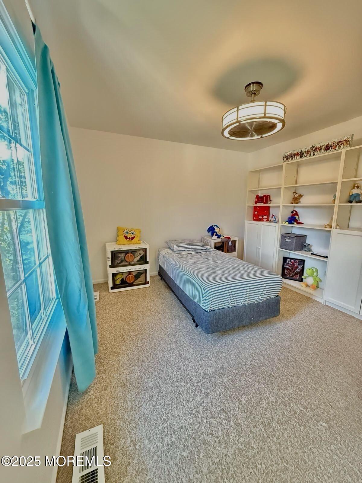 8 Hedgewood Road Howell, NJ 07731 - Photo 9 of 17 a bedroom with furniture and a chandelier