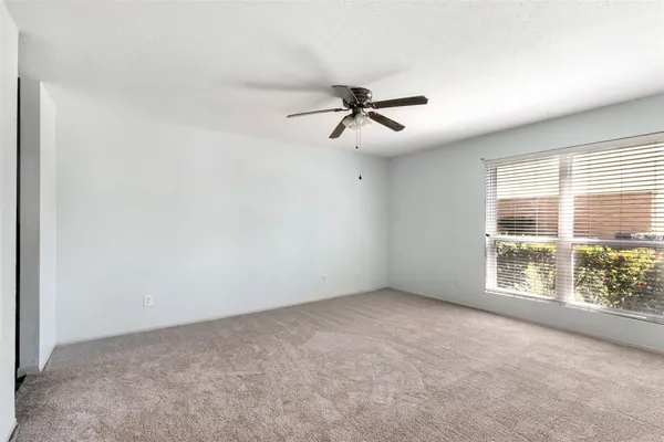 a view of room with a ceiling fan and window