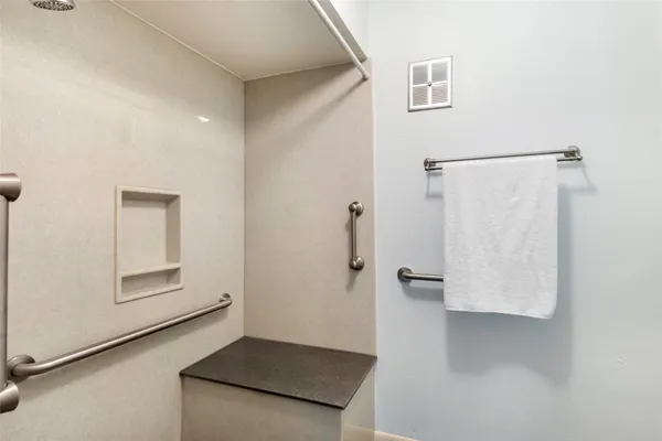 a view of an empty room with closet and cabinet