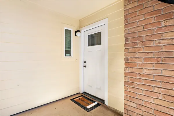 a view of an empty room and wooden floor