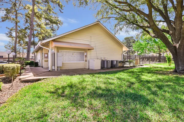 a view of a house with backyard and sitting area