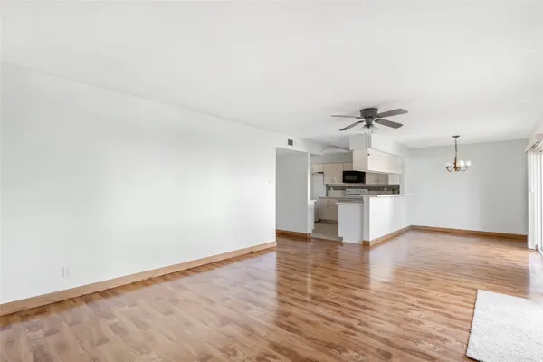 a view of kitchen with microwave and white cabinets