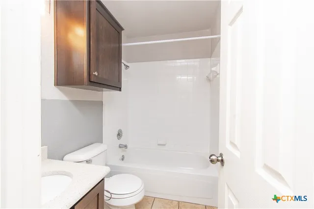 a bathroom with a toilet a sink and bathtub