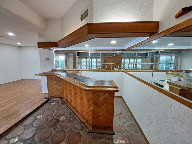 a large kitchen with kitchen island granite countertop a large counter top and stainless steel appliances