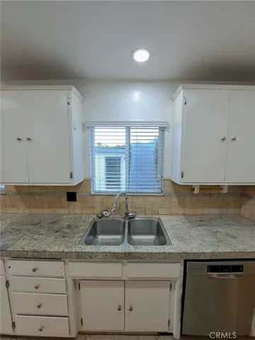 a view of a refrigerator with wooden cabinets