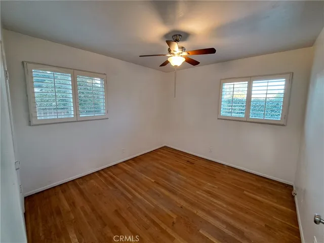 a view of a room that has a large window and front door