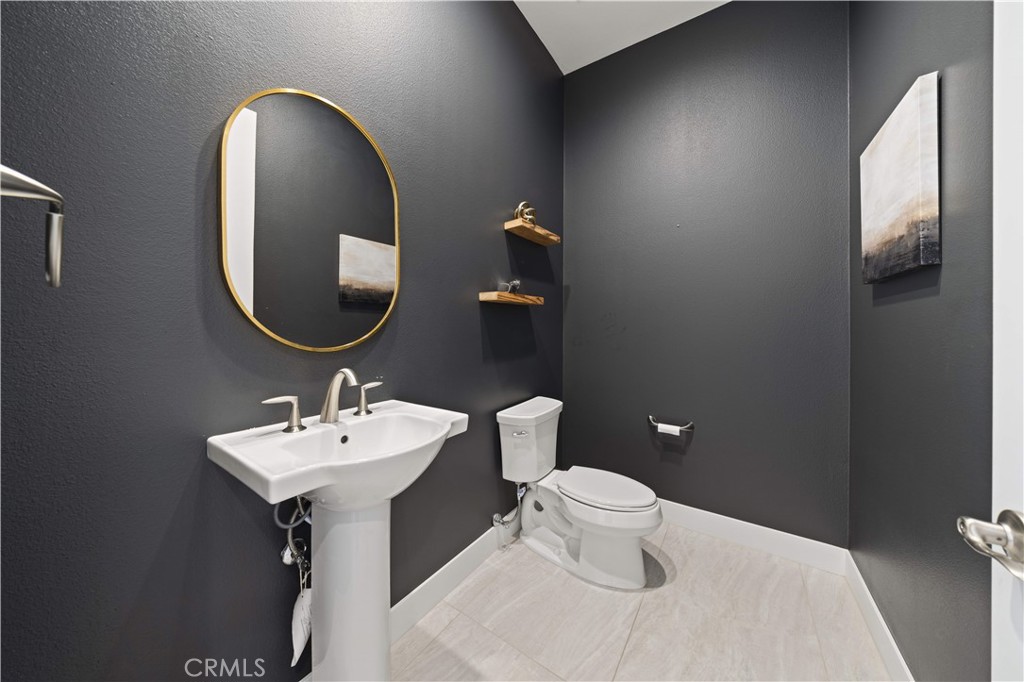 12545 North Silver Spur Court Porter Ranch, CA 91326 - Photo 13 of 22 a bathroom with a toilet sink and mirror