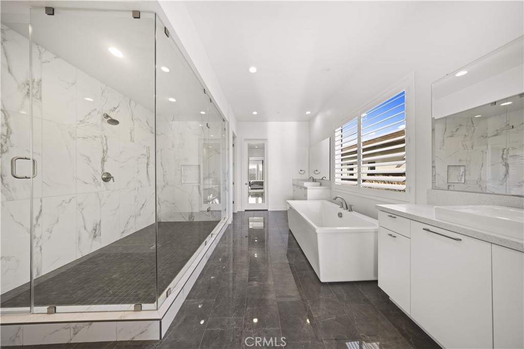 12545 North Silver Spur Court Porter Ranch, CA 91326 - Photo 15 of 22 a bathroom with a tub sink shower and mirror