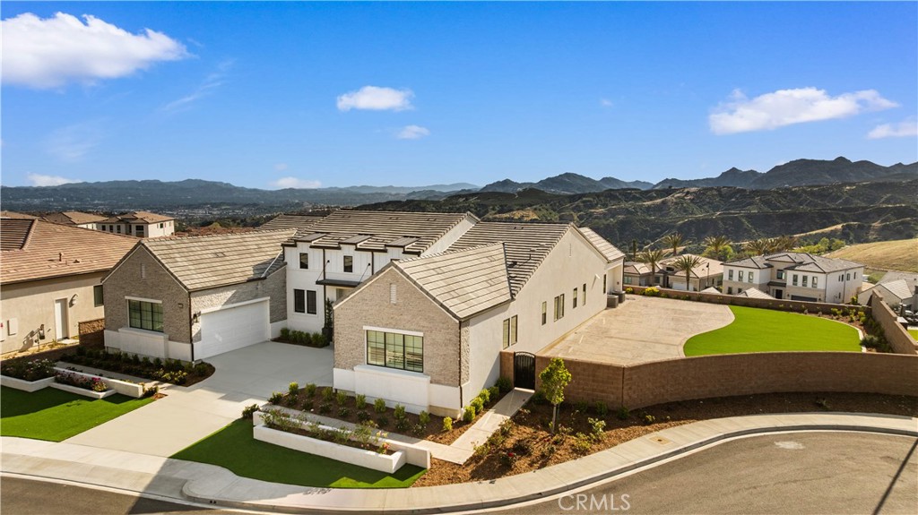 12545 North Silver Spur Court Porter Ranch, CA 91326 - Photo 2 of 22 a view of a white house with a yard and lake view