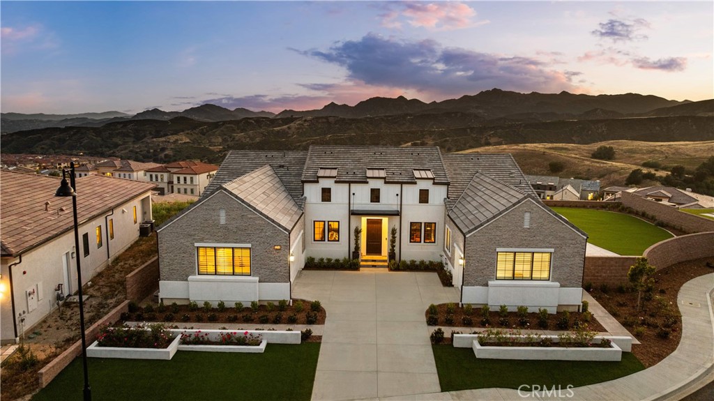 12545 North Silver Spur Court Porter Ranch, CA 91326 - Photo 3 of 22 a front view of a house with a yard