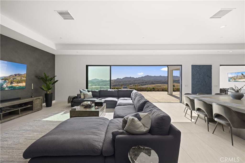 12545 North Silver Spur Court Porter Ranch, CA 91326 - Photo 8 of 22 a living room with furniture and a flat screen tv