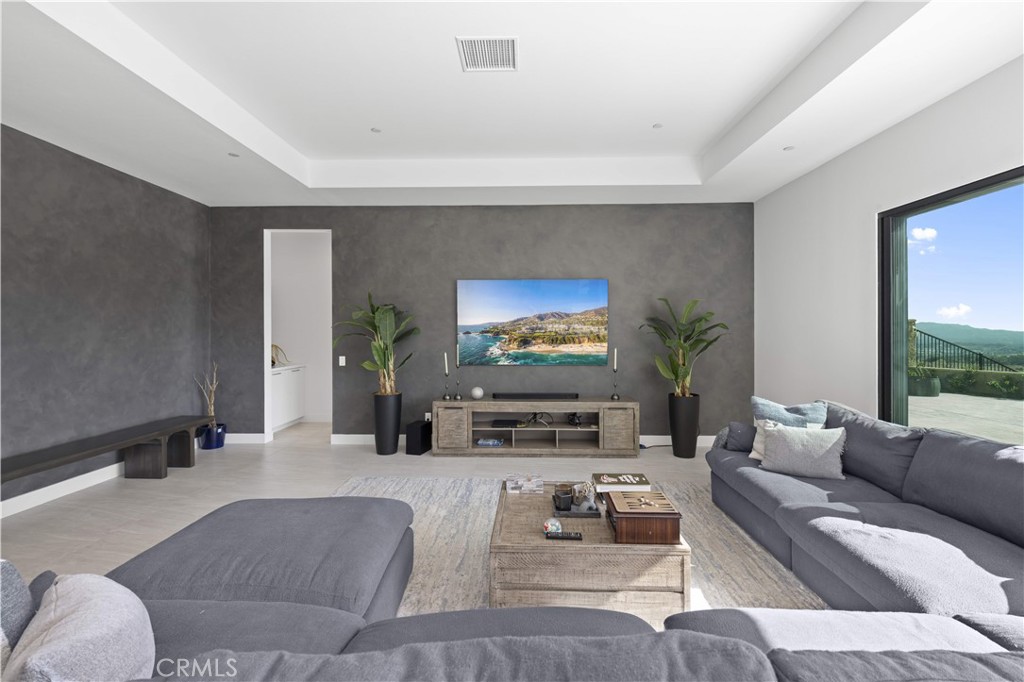 12545 North Silver Spur Court Porter Ranch, CA 91326 - Photo 9 of 22 a living room with furniture and a flat screen tv