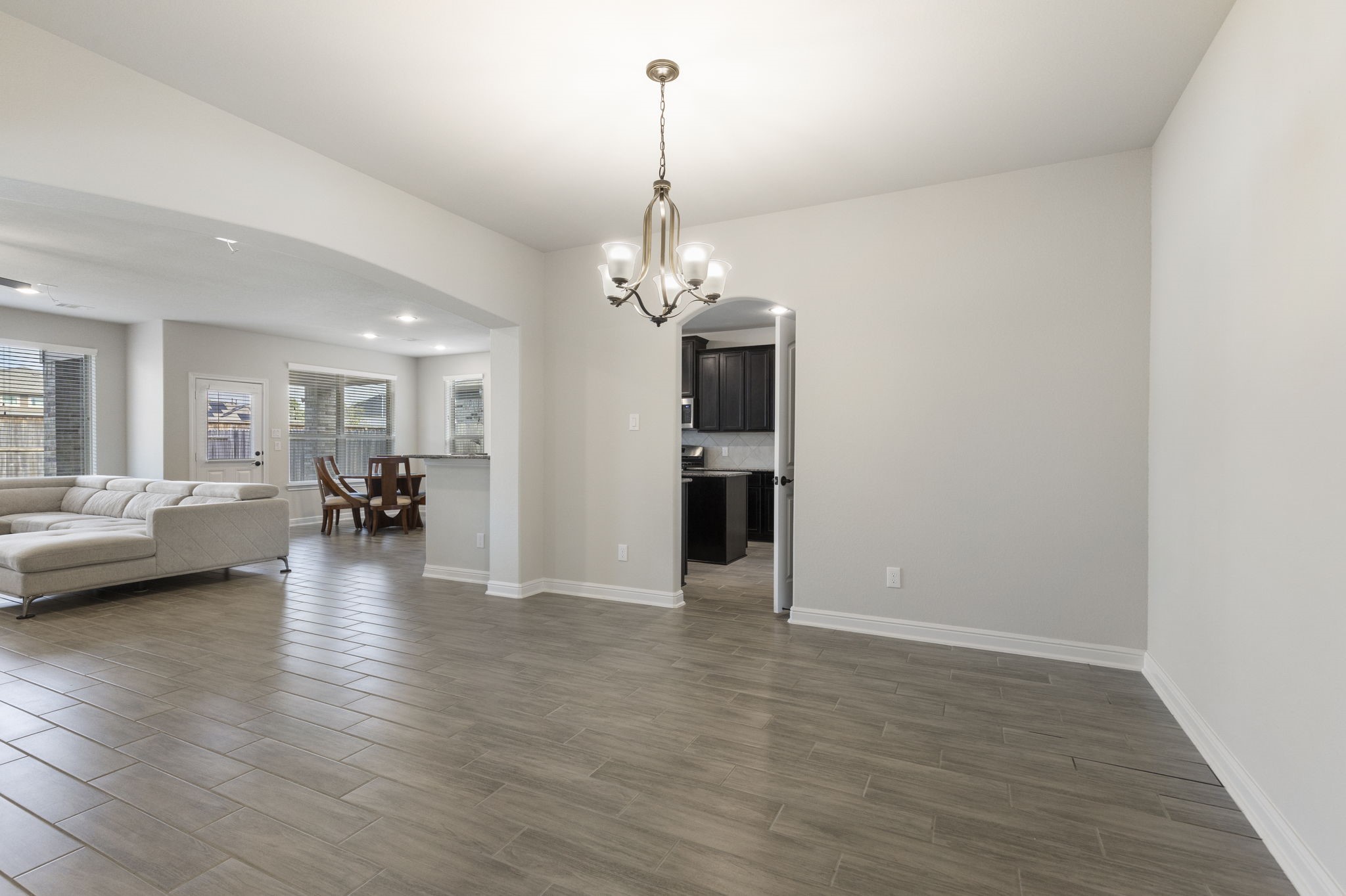 2819 Bradbury Hills Road Spring, TX 77373 - Photo 13 of 50 Experience elegant dining in this inviting space, seamlessly connecting to a bright, open living area perfect for entertaining.