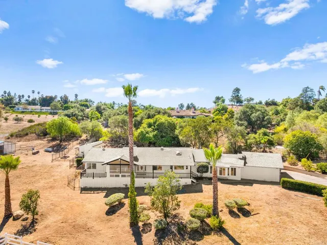 a view of empty room with a fireplace and window