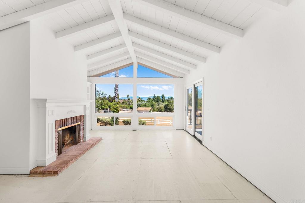 758 Verde Avenue Fallbrook, CA 92028 - Photo 16 of 71 a view of a livingroom with a fireplace a ceiling fan and windows