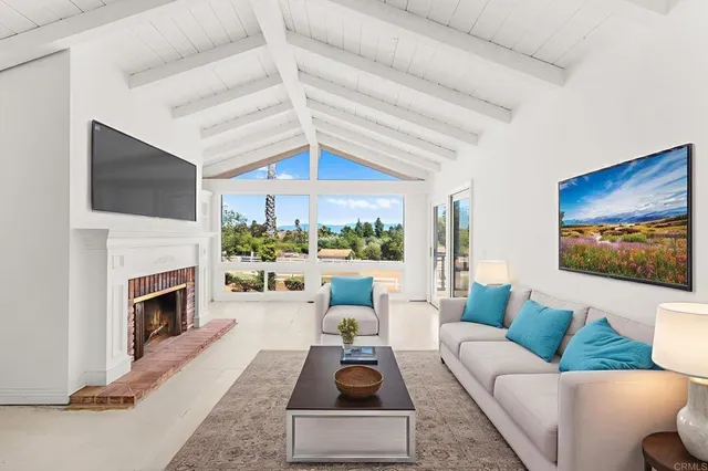an empty room with chandelier fan and windows