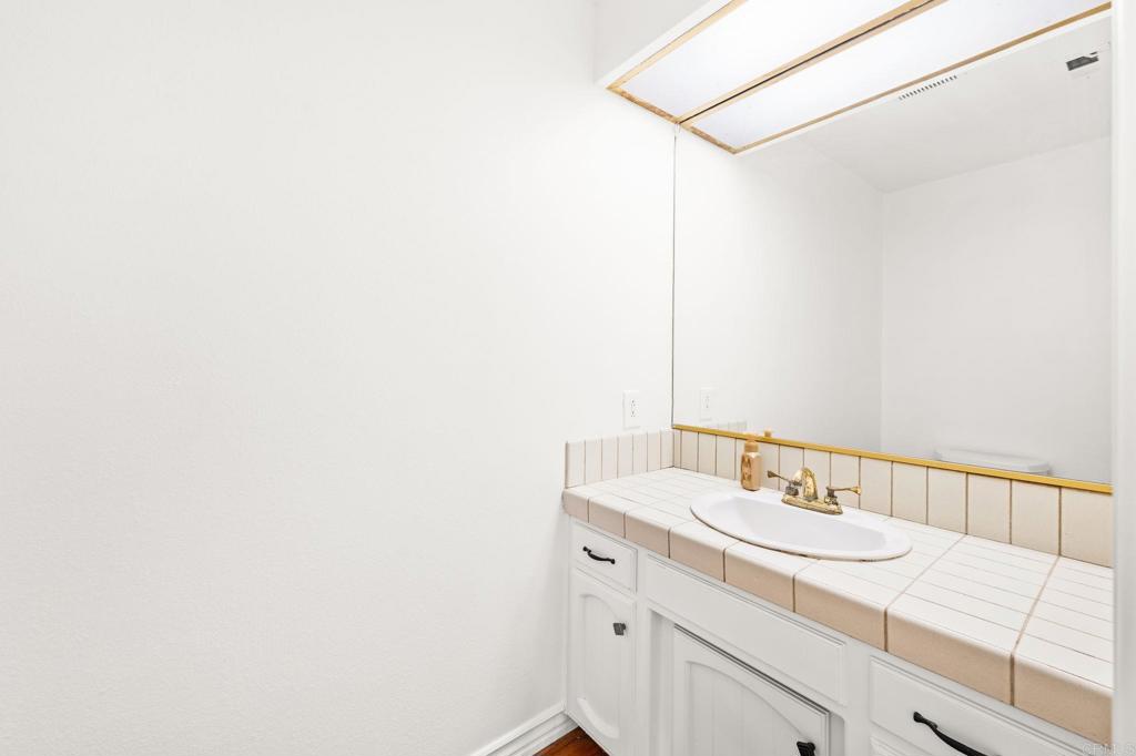758 Verde Avenue Fallbrook, CA 92028 - Photo 24 of 71 a bathroom with a sink and a mirror
