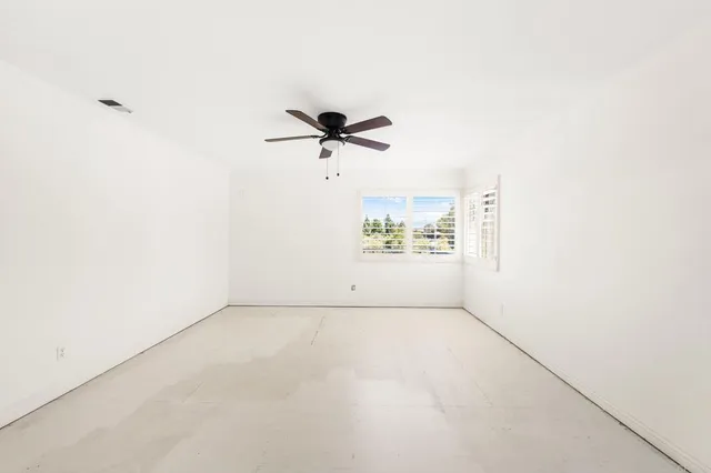 a kitchen with stainless steel appliances wooden floor and a refrigerator
