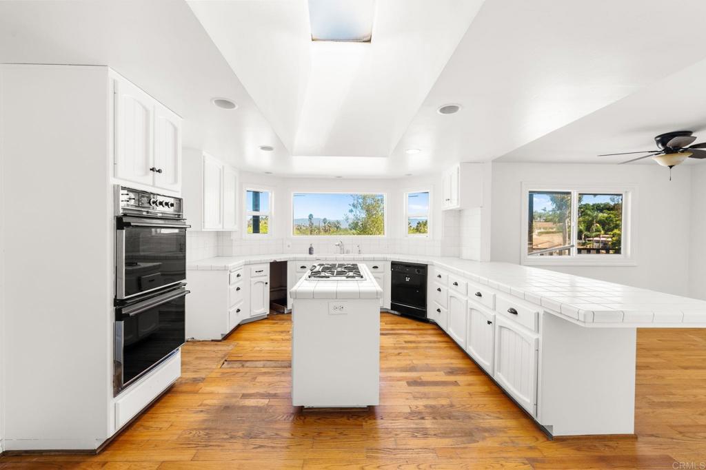 758 Verde Avenue Fallbrook, CA 92028 - Photo 39 of 71 a large kitchen with stainless steel appliances kitchen island granite countertop a refrigerator and a stove