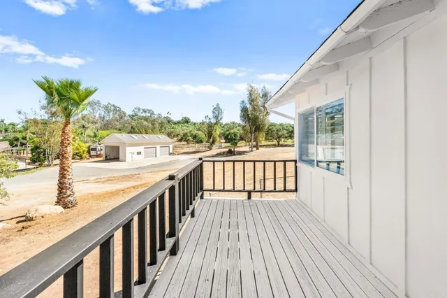 a view of a house with a wooden deck
