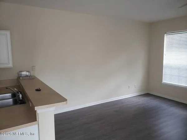 a view of a workspace with wooden floor