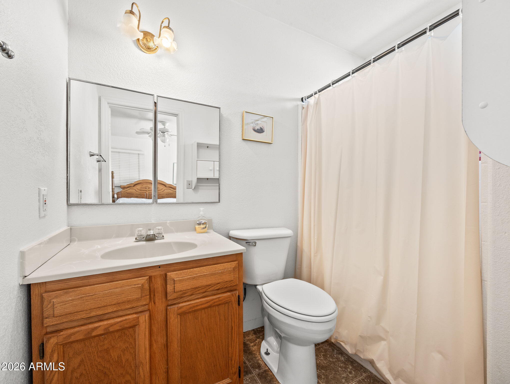 18420 Peeples Valley Road Peeples Valley, AZ 86332 - Photo 23 of 31 a bathroom with a sink a toilet and a mirror