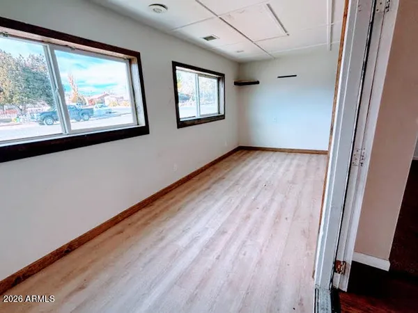 a view of a room with wooden floor and windows