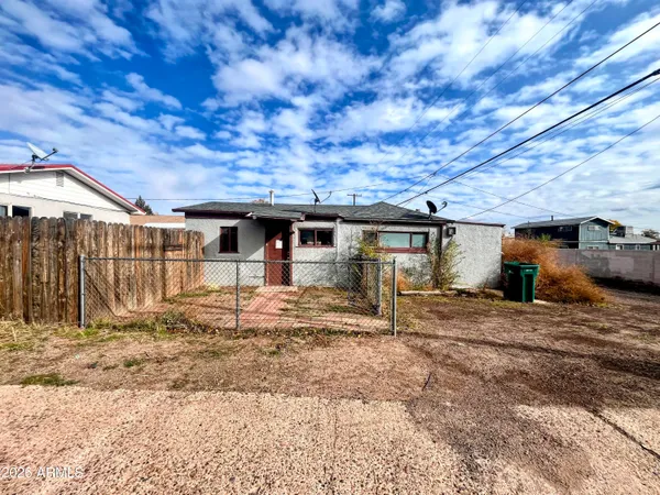 a view of a house with wooden fence