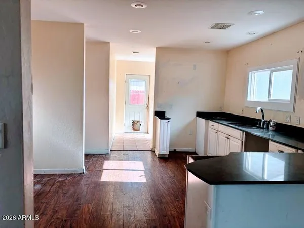 a kitchen with a sink and a large mirror