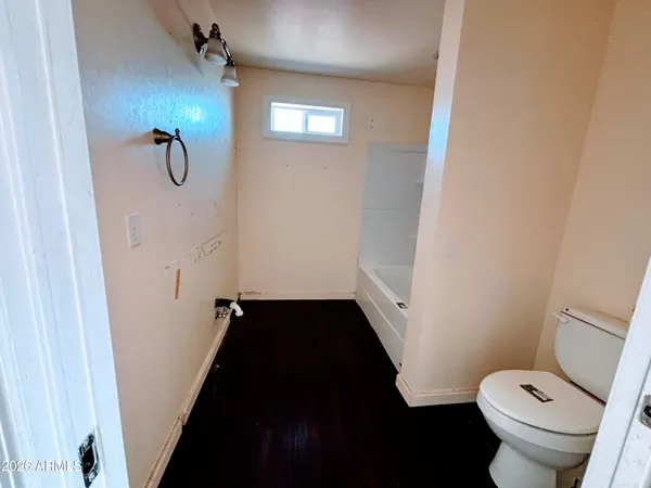 a bathroom with a granite countertop shower and a toilet