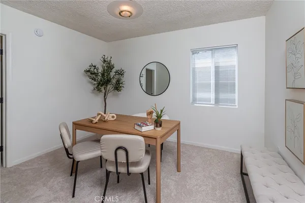 a dining room with furniture and window