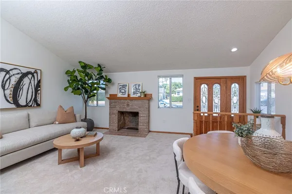 a living room with furniture a fireplace and a table