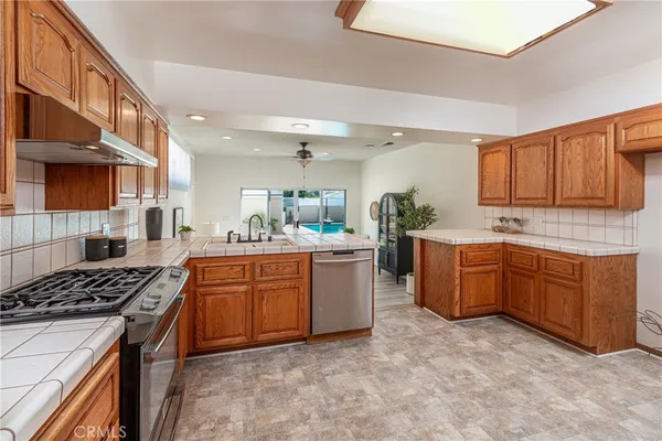 a kitchen with sink a stove and cabinets
