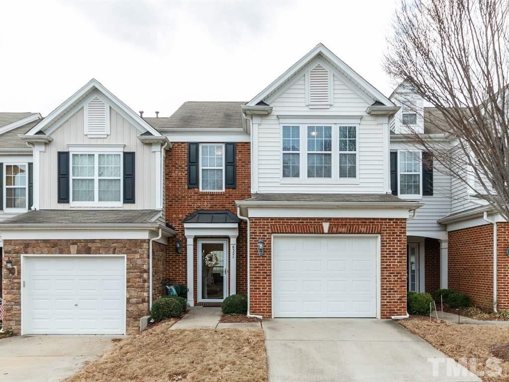 8321 Pilots View Drive Raleigh, NC 27617 - Photo 1 of 25 a front view of a house with a yard and garage