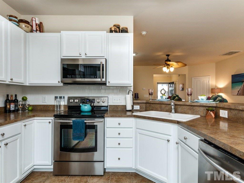 8321 Pilots View Drive Raleigh, NC 27617 - Photo 12 of 25 a kitchen with cabinets stainless steel appliances a sink and a microwave