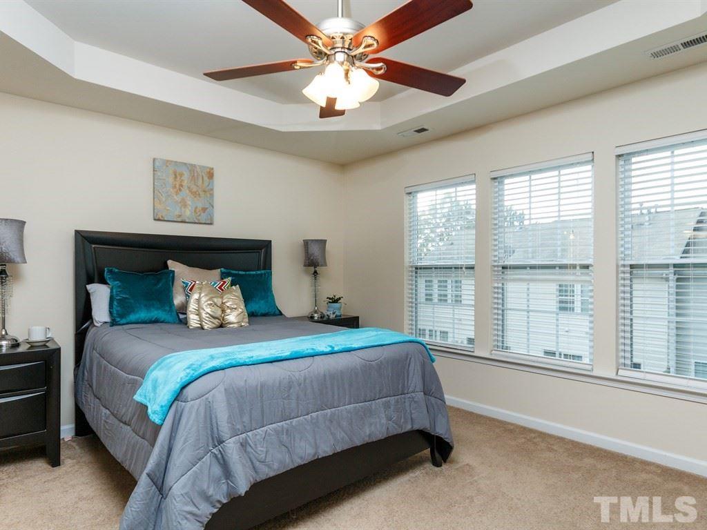8321 Pilots View Drive Raleigh, NC 27617 - Photo 15 of 25 a bedroom with a large bed and a large window
