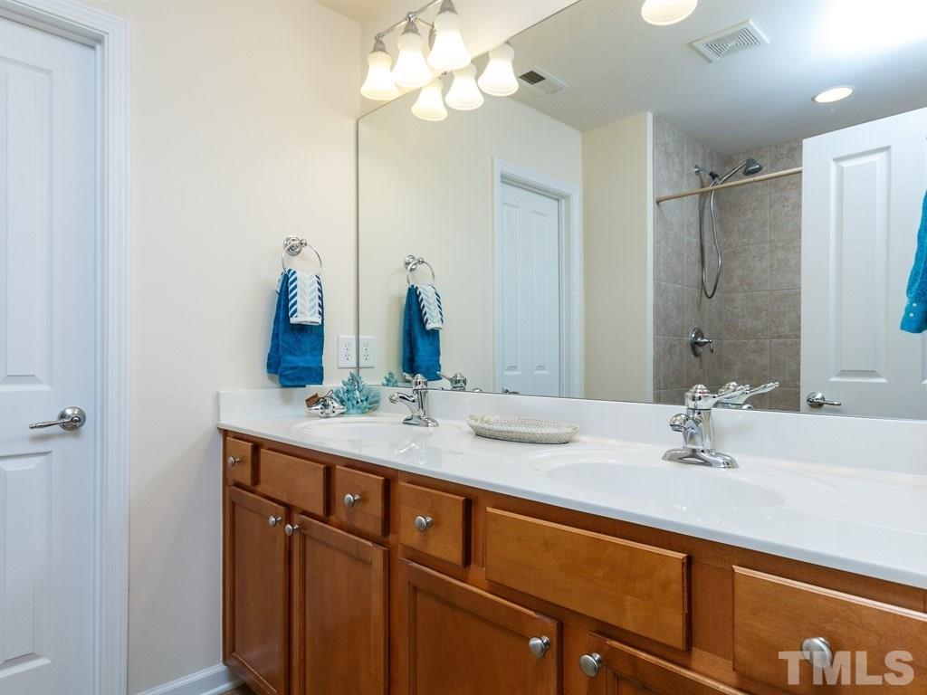 8321 Pilots View Drive Raleigh, NC 27617 - Photo 18 of 25 a bathroom with a sink and a mirror