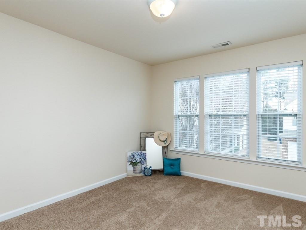 8321 Pilots View Drive Raleigh, NC 27617 - Photo 25 of 25 an empty room with wooden floor and windows