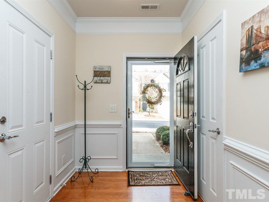 8321 Pilots View Drive Raleigh, NC 27617 - Photo 6 of 25 a view of a hallway with wooden floor and windows