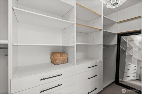a bedroom with a bed a couch and dresser