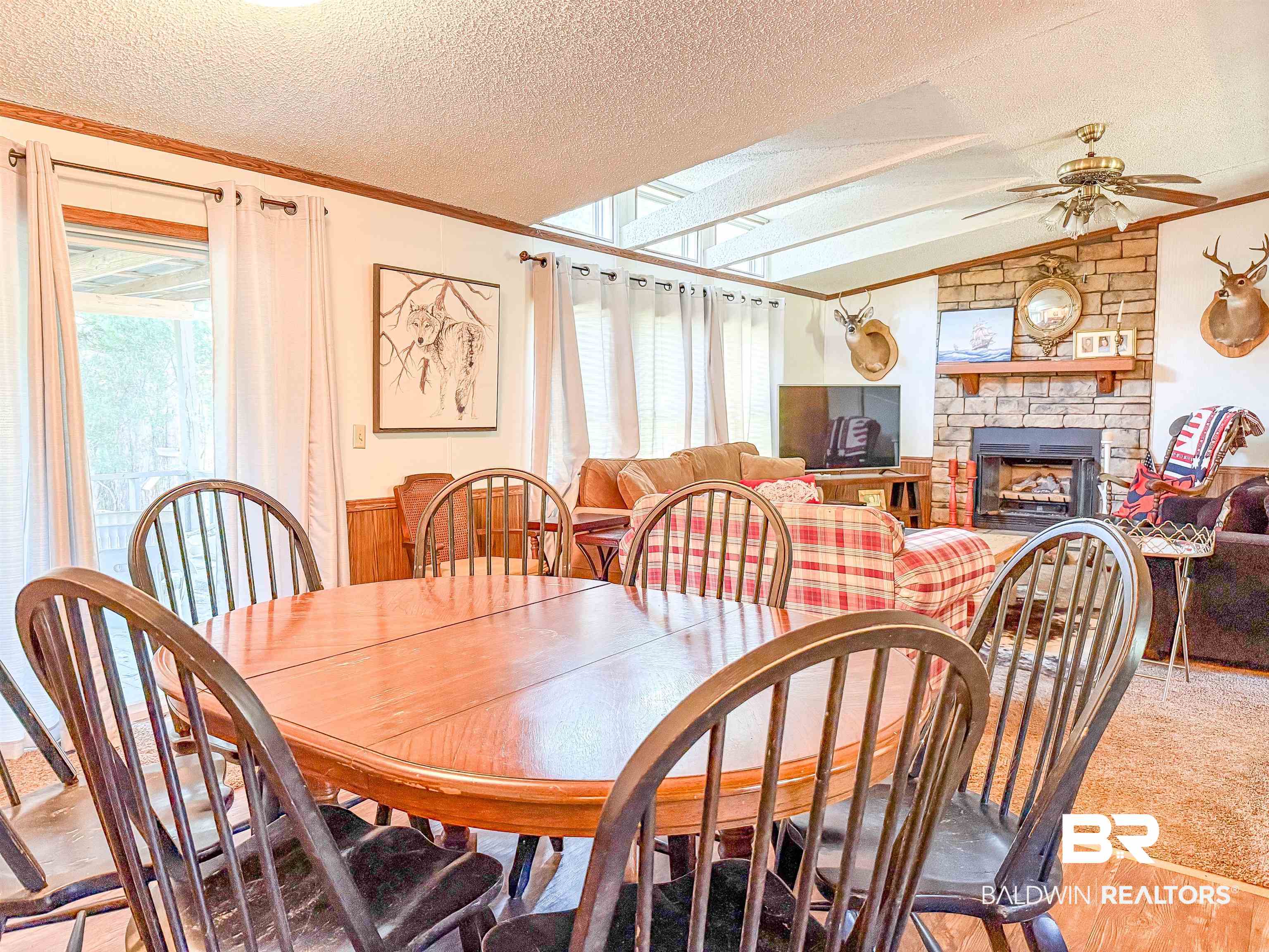 3346 Hoomesville Road Brewton, AL 36426 - Photo 7 of 16 Dining area with ornamental molding, a textured ceiling, a fireplace, ceiling fan, and lofted ceiling