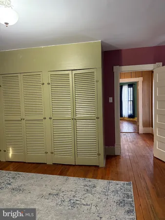 a view of a room with wooden floor