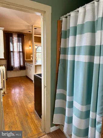 a view of bathroom with a shower and a mirror