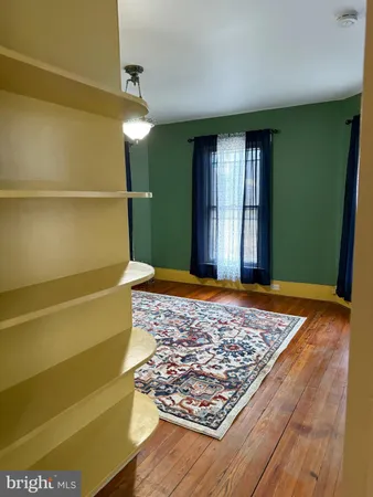 a view of livingroom with window and hardwood floor